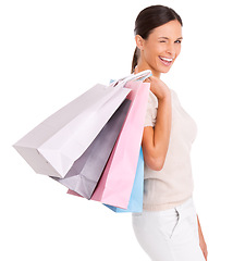 Image showing Wink, shopping and portrait of woman on a white background with bag for sale, discount and deal. Excited, happy customer and isolated person for retail, consumerism and fashion purchase in studio