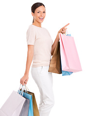 Image showing Pointing, shopping and portrait of woman on a white background with bag for sale, discount and deal news. Fashion, happy customer and isolated person for retail, consumerism and purchase in studio