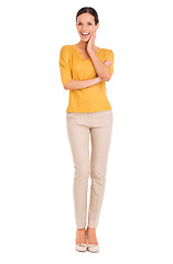 Image showing Woman, fashion and portrait for beauty, excited and happy in outfit in studio for minimalist style. Female person, smile and yellow top by white background, hand on face and confident in apparel