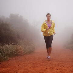 Image showing Woman, health and running in forest with fitness for exercise, morning routine and workout with fog and confidence. Athlete, person and cardio with sportswear on outdoor trail and woods for wellness