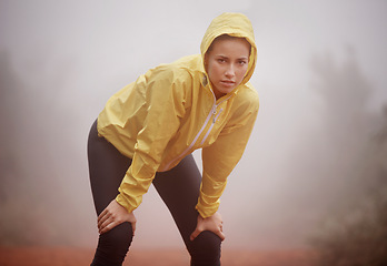 Image showing Winter, portrait and tired fitness woman in nature for training, wellness or cardio in the rain. Sports, face and fatigue by female runner in forest for breathing, break or recovery from workout run