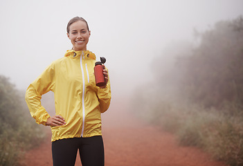 Image showing Nature, fitness and portrait of woman drinking water for running on dirt road with marathon training. Sports, workout and athlete enjoying beverage for hydration on misty outdoor cardio exercise.