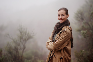 Image showing Travel, portrait and happy woman with arms crossed in nature for hiking, wellness or walk outdoor in winter. Face, pride person outdoor for fresh air, camping or adventure, journey or campsite fun