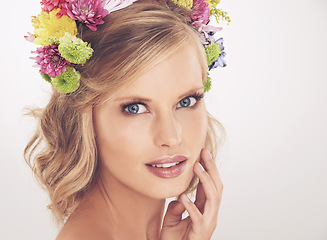 Image showing Woman, face and flower crown in studio with makeup and confidence for cosmetics, beauty and skincare. Spring aesthetic, model and floral headband with mockup space and wellness on white background