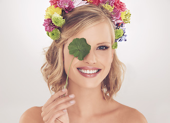 Image showing Woman, portrait and happy with flowers on crown in studio with makeup and leaf for cosmetics and skincare. Spring aesthetic, model and face or smile with floral headband or beauty on white background