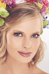 Image showing Woman, portrait and flowers on crown in studio with makeup, smile and confidence for cosmetics and beauty. Spring aesthetic, model and floral headband with skincare and wellness on white background