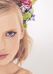 Image showing Woman, portrait and confidence with flowers on crown in studio with makeup for cosmetics and skincare. Spring aesthetic, model and face or serious with floral headband and beauty on white background