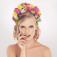 Image showing Woman, portrait and flowers on crown in studio with makeup and confidence for cosmetics, beauty and skincare. Spring aesthetic, model and face or floral headband with wellness on white background