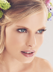 Image showing Woman, face and flowers on crown in studio with makeup and confidence for cosmetics, beauty and skincare. Spring aesthetic, model and floral headband with glowing skin or wellness on white background