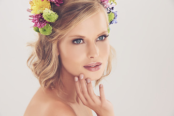 Image showing Woman, thinking and flowers on crown in studio with makeup and confidence for cosmetics, beauty and skincare. Spring aesthetic, face and floral headband with mockup space and idea on white background