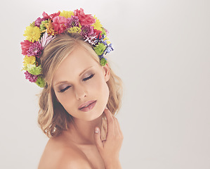 Image showing Woman, face and flowers on crown in studio with makeup and confidence for cosmetics, beauty and skincare. Spring aesthetic, model and floral headband with mockup space or wellness on white background