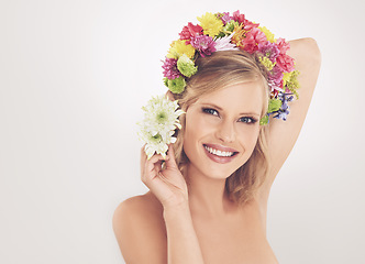 Image showing Woman, portrait and flowers on crown in studio with makeup and happy for cosmetics, beauty or skincare. Spring aesthetic, model and face or floral headband with mockup or wellness on white background