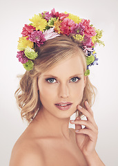 Image showing Woman, portrait or flower on crown in studio with makeup or confidence for cosmetics, beauty or skincare. Spring aesthetic, model and face or floral headband with glow or wellness on white background