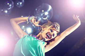 Image showing Happy, woman and dance at club with disco, music and movement with energy at party. Girl, smile and enjoy rave culture at techno, nightclub and person moving to sound or audio at event from low angle