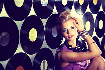 Image showing Woman, dj and portrait in record studio with headphones at rave party, sitting and wall of vinyls for music event. Female producer, mixer and sound industry for events, nightclubs and entertainment