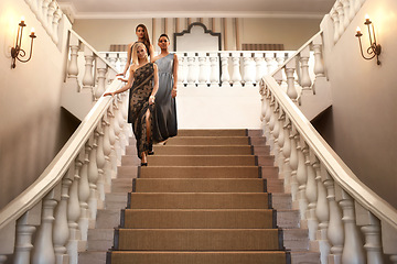 Image showing Women, stairs and dress for gala, event and luxury party with confidence and fashion. Friends, classy and elegant group with expensive, fancy and designer clothes with glamour and gown at mansion