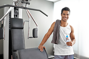 Image showing Happy, portrait and man at gym with water bottle for recovery after exercise for body building. Healthy, fitness and person relax after workout with hydration for benefits to wellness in Mexico