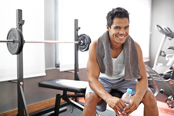 Image showing Happy, man and portrait at gym with water bottle for recovery after exercise and body building. Healthy, fitness or person relax after workout with liquid hydration for benefits to wellness in Mexico