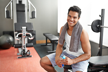 Image showing Gym, portrait and happy man with water bottle for recovery after exercise and body building. Healthy, fitness and person relax after workout with liquid hydration for benefits to muscle and wellness
