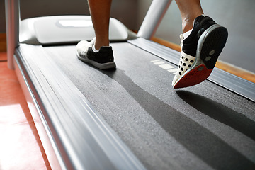 Image showing Fitness, feet and person running on treadmill in gym for health, wellness and body training. Active, shoes and closeup of athlete with workout or exercise on cardio machine at sports center.