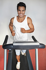 Image showing Smile, fitness and portrait of man on treadmill in gym for health, wellness and body training. Happy, running and male athlete on cardio machine for speed exercise or workout in sports center.