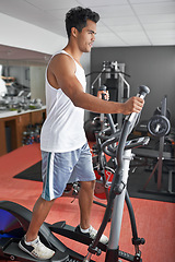 Image showing Fitness, health and man with air walker in gym for commitment to cardio improvement workout routine. Exercise, running or walking with confident young athlete on equipment for full body training