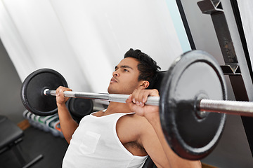 Image showing Bench, press and man at gym for workout, exercise and body building in Mexico. Healthy, person and weightlifting challenge for strong muscle, fitness or progress in training arms with barbell at club