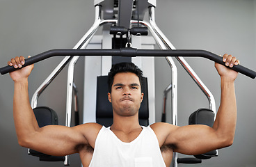 Image showing Fitness, pull down machine and man in studio on gray background for training or workout at gym. Exercise, health or shoulder press and body builder with equipment for wellness, strength or power