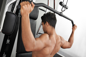 Image showing Exercise, pull down machine and man in studio on gray background for training or workout at gym. Fitness, health or shoulder press and body builder with equipment for wellness, strength or power