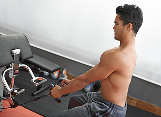 Image showing Fitness, rowing machine and shirtless man in gym for health, wellness or bodybuilding workout. Exercise, strong and focus with body of young bodybuilder athlete training on equipment for improvement