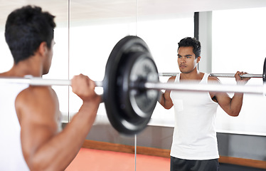 Image showing Man, barbell and weightlifting at mirror for training exercise as bodybuilder for workout strength, wellness or routine. Male person, equipment and reflection in Miami for healthy, biceps or sport