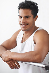 Image showing Happy, fitness and portrait of man at gym in studio for body workout or muscle training. Smile, sports and young male athlete at steel bar for health or wellness exercise by white background.