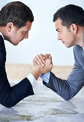 Image showing Businessman, handshake and arm wrestle for competition, challenge or strength on table at the office. Serious man, corporate employees or business partners shaking hands for game, contest or battle