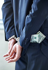 Image showing Business person, hands and cash with handcuffs for bribe, secret or corruption in financial crime. Closeup or rear view of employee with pocket money, paper or laundering finance in bribery or fraud