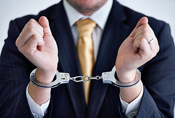 Image showing Hands, person in corporate and handcuffs for fraud or bribery, business deal gone wrong with justice or jail. Professional crime, corruption or money laundering, shackles for prison with criminal