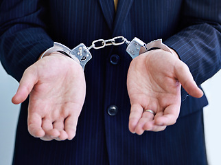 Image showing Hands, person in business and handcuffs for fraud or bribery, suspicious professional deal with justice or jail. Crime, corruption or money laundry, shackles for prison with thief or criminal