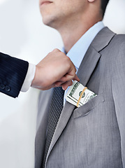 Image showing Businessman, hands and bribe with money for fraud, payment or deal on a white studio background. Closeup of man or employee taking cash, dollar bill or paper in scam, secret or bribery from colleague