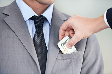 Image showing Businessman, hands and bribe with cash for fraud, payment or deal on a white studio background. Closeup of man or employee taking money, dollar bill or paper in scam, secret or bribery from colleague