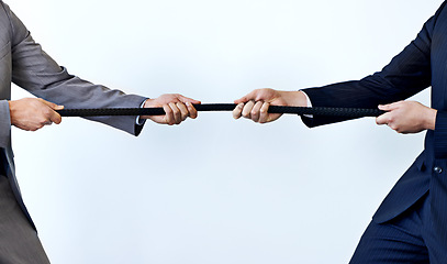 Image showing Business people, rope and tug of war for challenge, mission or strength of rivals on a blue studio background. Closeup of employees or colleagues hands pulling strong cable for competition on mockup