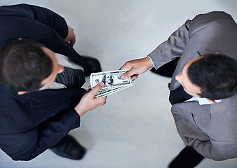 Image showing Businessman, money and bribe above with dollar bills for payment, deal or agreement at office. Top view of man, colleagues or employees giving cash, paper or exchange in bribery, scam or fraud