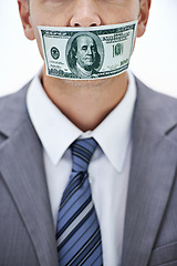 Image showing Business man, cash and mouth for silence, bribe or corruption with suit in studio by white background. Person, money and quiet for corporate crime with fraud, finance or illegal payment at job in USA