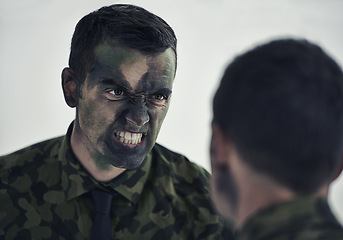 Image showing Soldier, man and mirror with camouflage for war with thinking, decision and anger to fight war. Person, agent or officer in military with reflection for choice, uniform and face paint for conflict