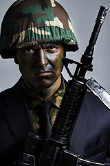 Image showing Soldier, man and gun in portrait with camouflage face paint for conflict, war and suit for corporate crime. Person, rifle and helmet in military gear with anger for battle, challenge or human rights