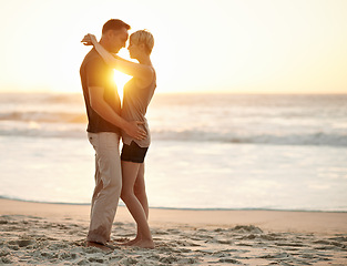 Image showing Couple, embrace and romance in sea at sunset to relax, vacation and happy in trip. Partners, together and water in beach to enjoy, calm and smile for love of marriage in honeymoon and holiday