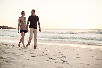 Image showing Couple, walking and beach relax for holiday connection in California or marriage commitment, bonding or travel. Man, woman and explore tropical island at sunset or paradise honeymoon, date or seaside
