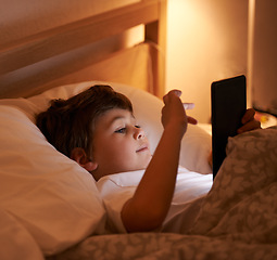 Image showing Child, tablet and bedroom with night, smile and technology for social media or learning. Boy, bed and connectivity for knowledge, growth and elearning or internet surfing at home with touchscreen