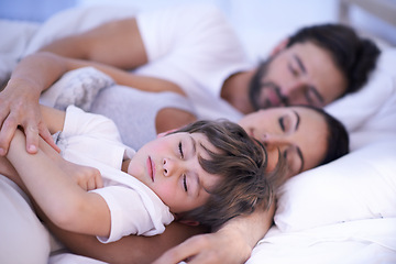 Image showing Parents, boy and sleeping in bedroom, home and embrace for rest, peace and quiet with bonding. Father, mother and child in bed with blanket for fatigue, burnout and exhausted in night at family house