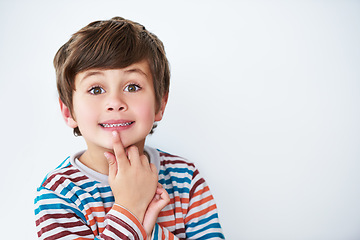 Image showing Portrait, kid and boy thinking in studio isolated on a white background mockup space. Face, idea and young child with cute facial expression, innocent and casual clothes on a backdrop in Australia