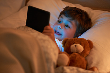 Image showing Boy, kid and tablet in bed at night with smile, reading or online game with app in family home. Child, bedroom and digital touchscreen for movie, cartoon and streaming subscription to relax in house