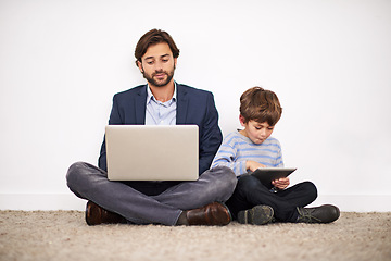 Image showing Father, laptop and kid with tablet on floor for learning, online education and relax at home. Child, dad and computer for internet, studying and family reading info on technology together by wall